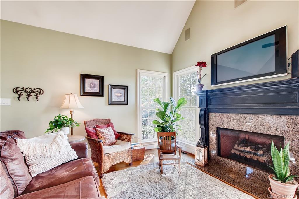 980 Ben Black Road Midland, NC 28107 - Photo 14 of 38 a living room with furniture a flat screen tv and a fireplace