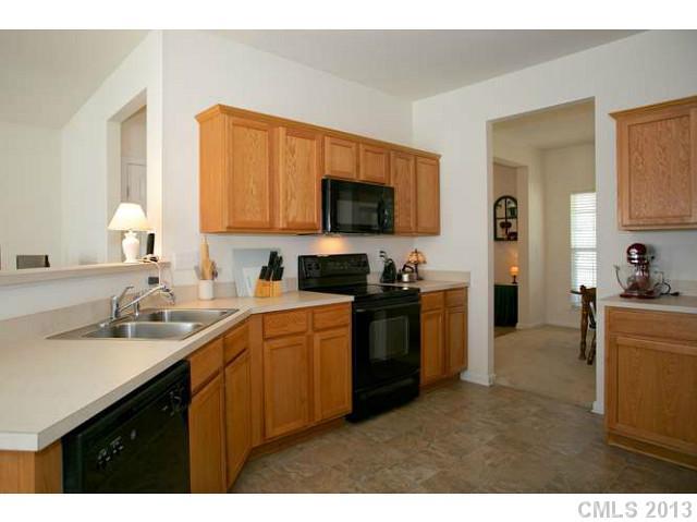 7312 April Mist Trail Huntersville, NC 28078 - Photo 2 of 11 a kitchen with a sink stove and refrigerator