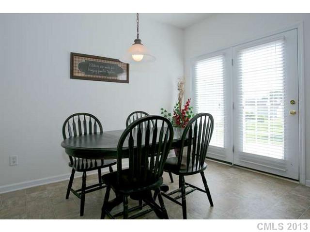 7312 April Mist Trail Huntersville, NC 28078 - Photo 4 of 11 a view of a dining room with furniture window and outside view