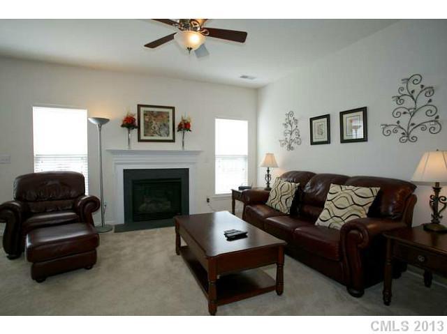 7312 April Mist Trail Huntersville, NC 28078 - Photo 6 of 11 a living room with furniture and a fireplace