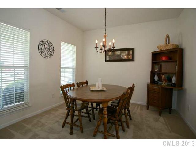 7312 April Mist Trail Huntersville, NC 28078 - Photo 7 of 11 a view of a dining room with furniture and chandelier