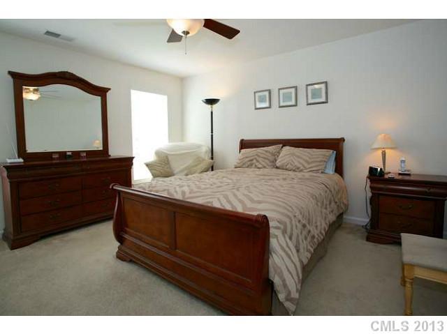 7312 April Mist Trail Huntersville, NC 28078 - Photo 8 of 11 a bedroom with a bed and a dresser
