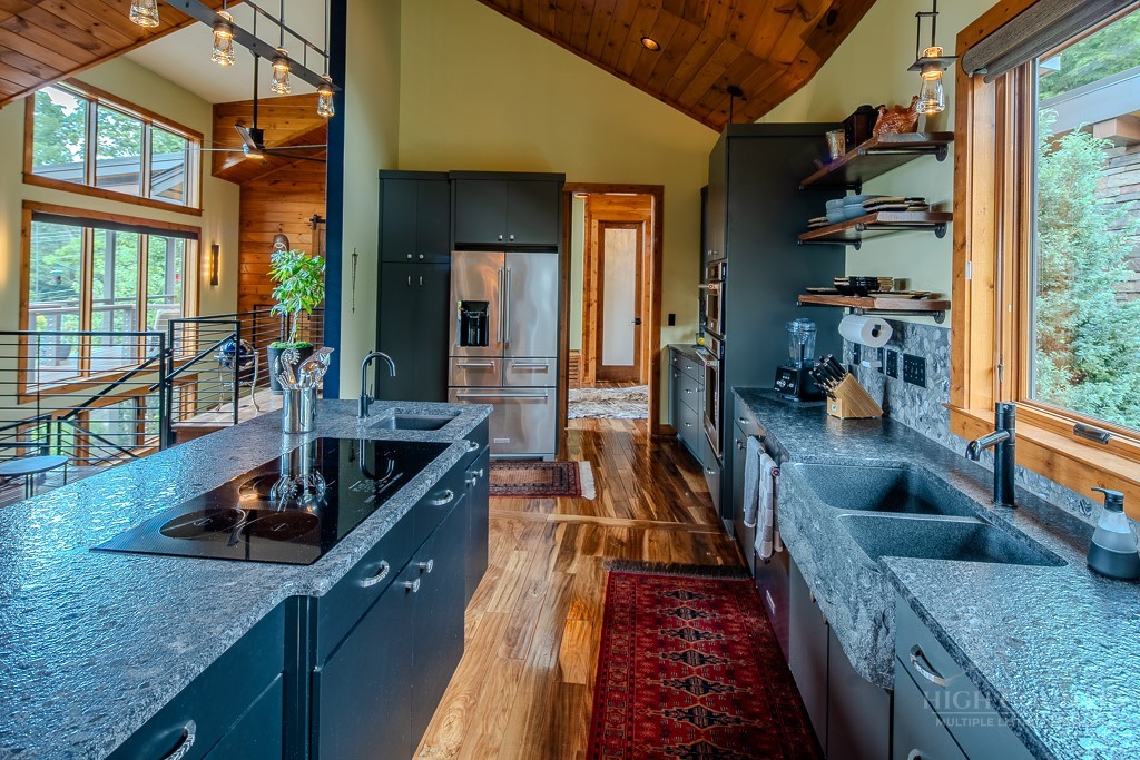 179 Adams Road Vilas, NC 28692 - Photo 12 of 50 an outdoor kitchen with granite countertop a sink and a large window