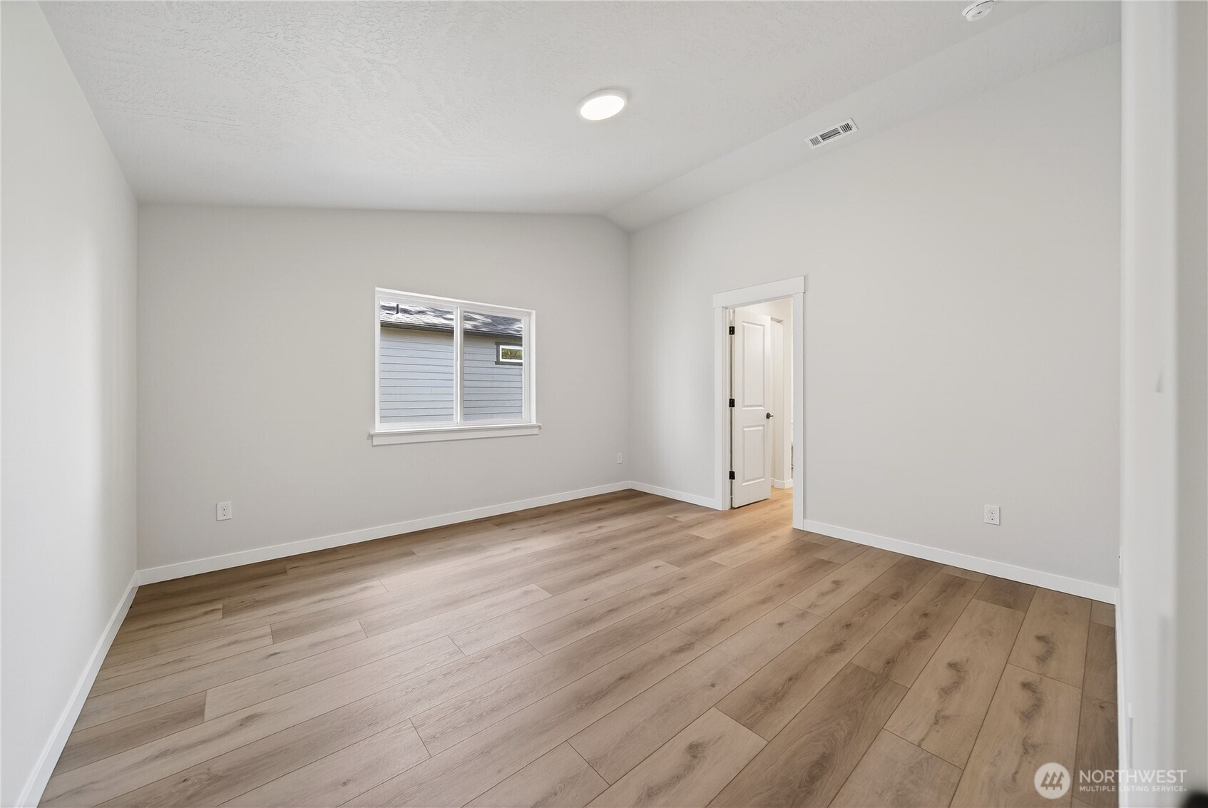 783 Ava Street Walla Walla, WA 99362 - Photo 9 of 12 an empty room with wooden floor and windows