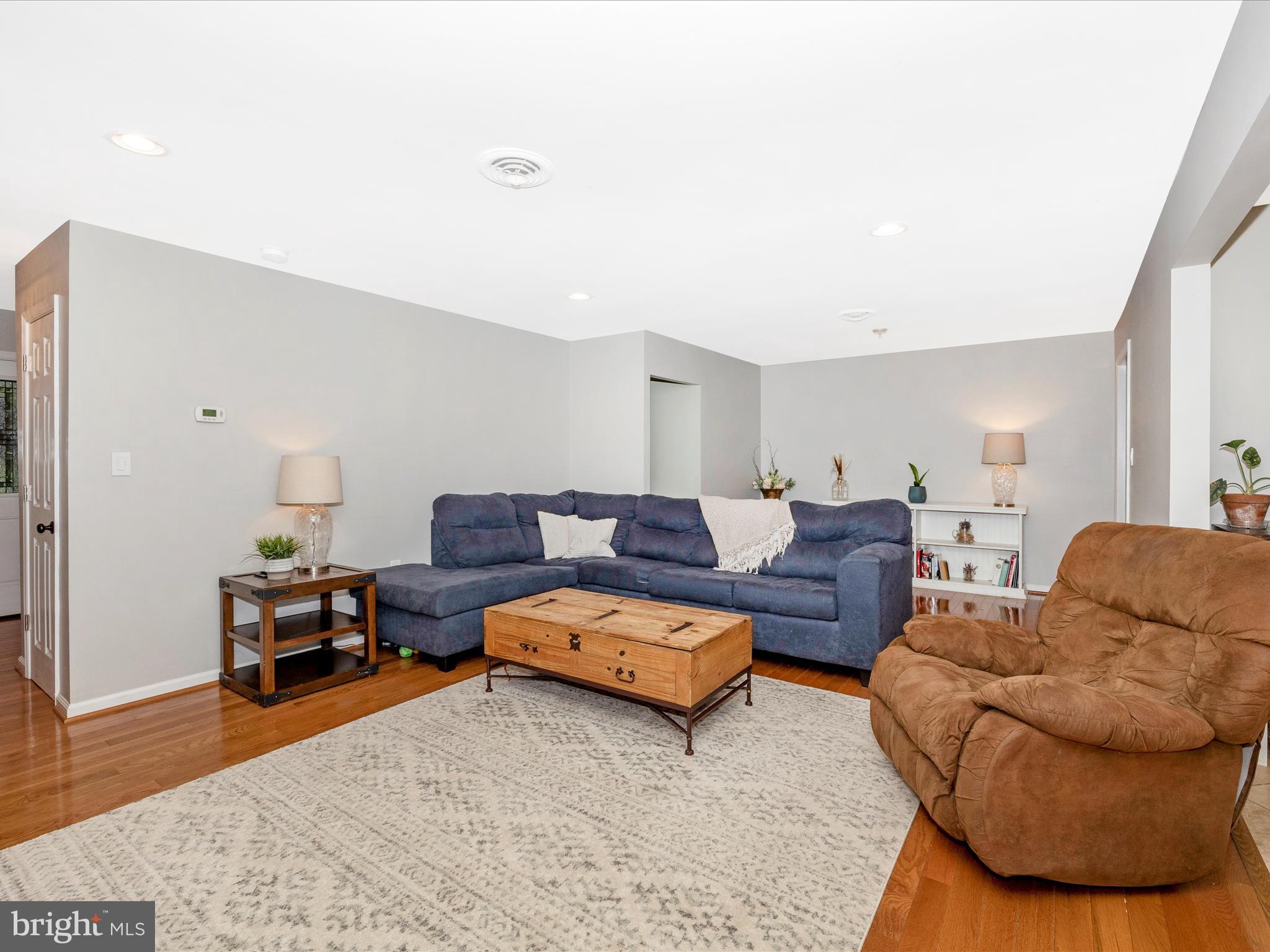 9204 Oak Tree Circle Frederick, MD 21701 - Photo 19 of 58 a living room with a couch and a wooden floor