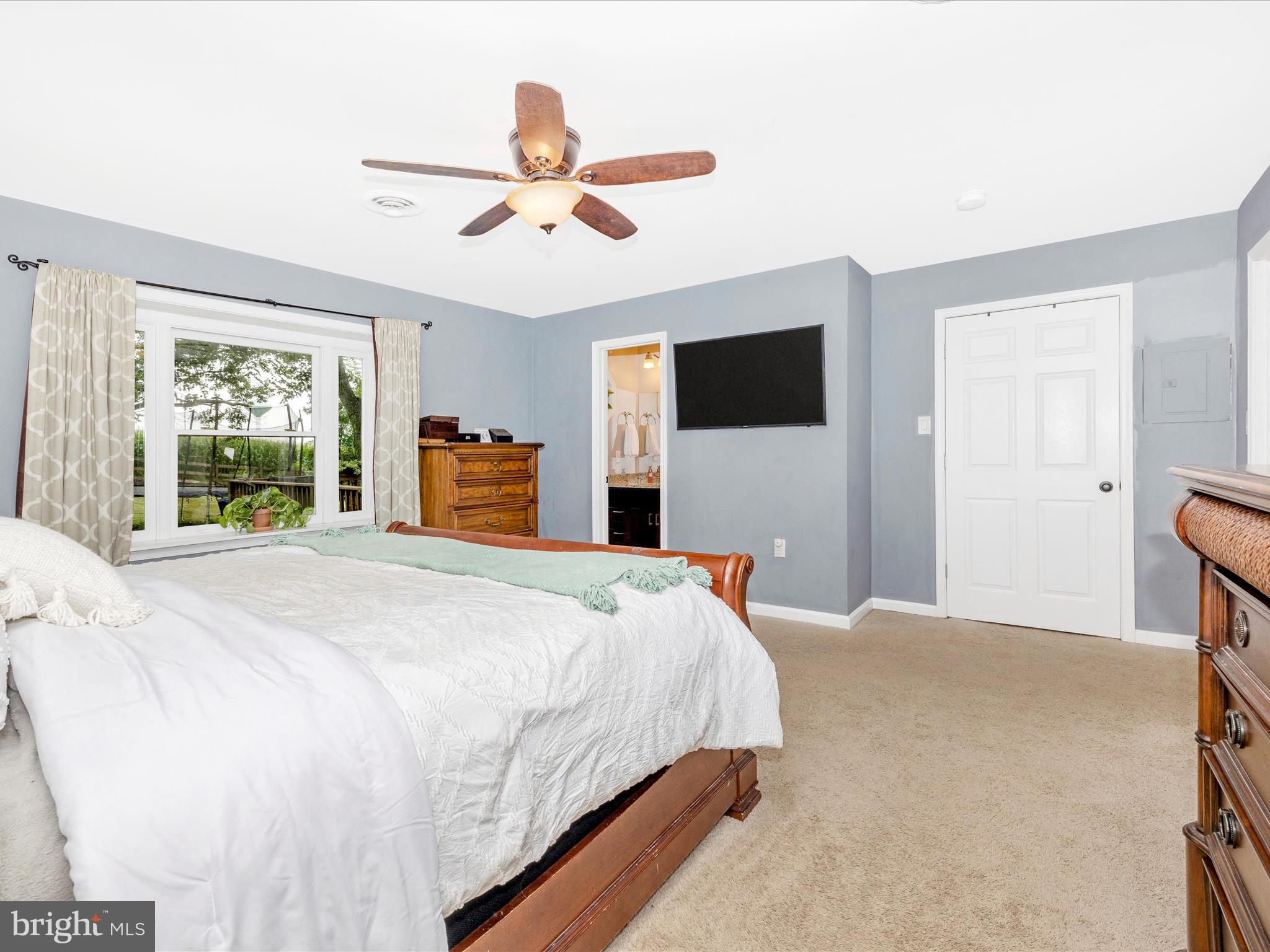 9204 Oak Tree Circle Frederick, MD 21701 - Photo 25 of 58 a bedroom with a large bed a flat tv screen and dresser