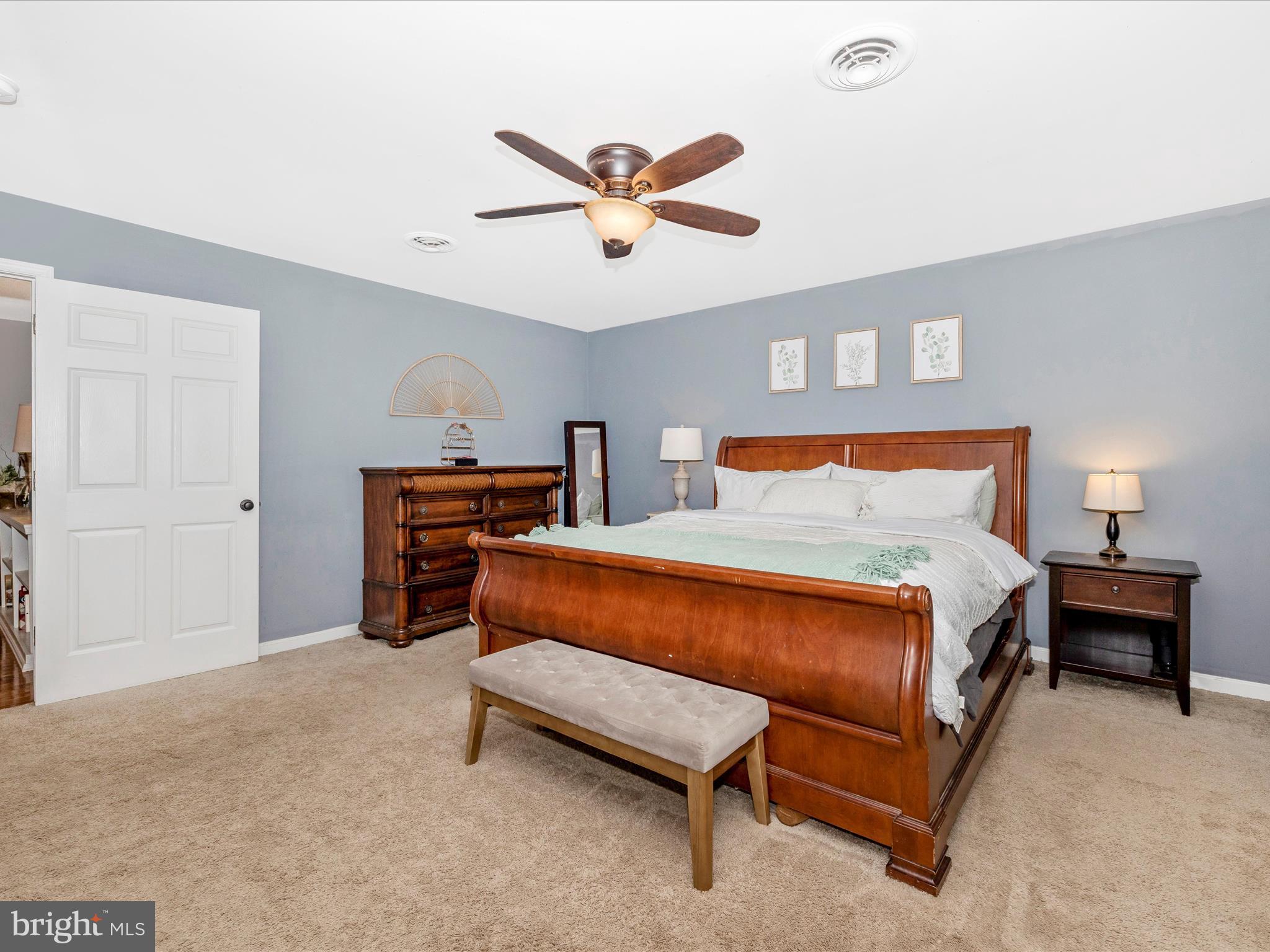 9204 Oak Tree Circle Frederick, MD 21701 - Photo 27 of 58 a bedroom with a bed and a chandelier