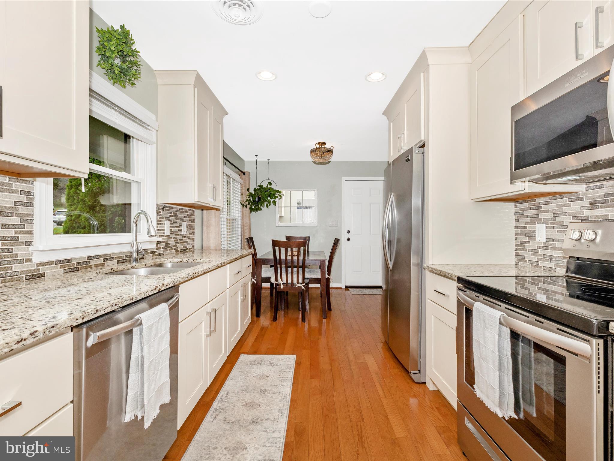9204 Oak Tree Circle Frederick, MD 21701 - Photo 3 of 58 a kitchen with stainless steel appliances granite countertop a stove a sink and a microwave