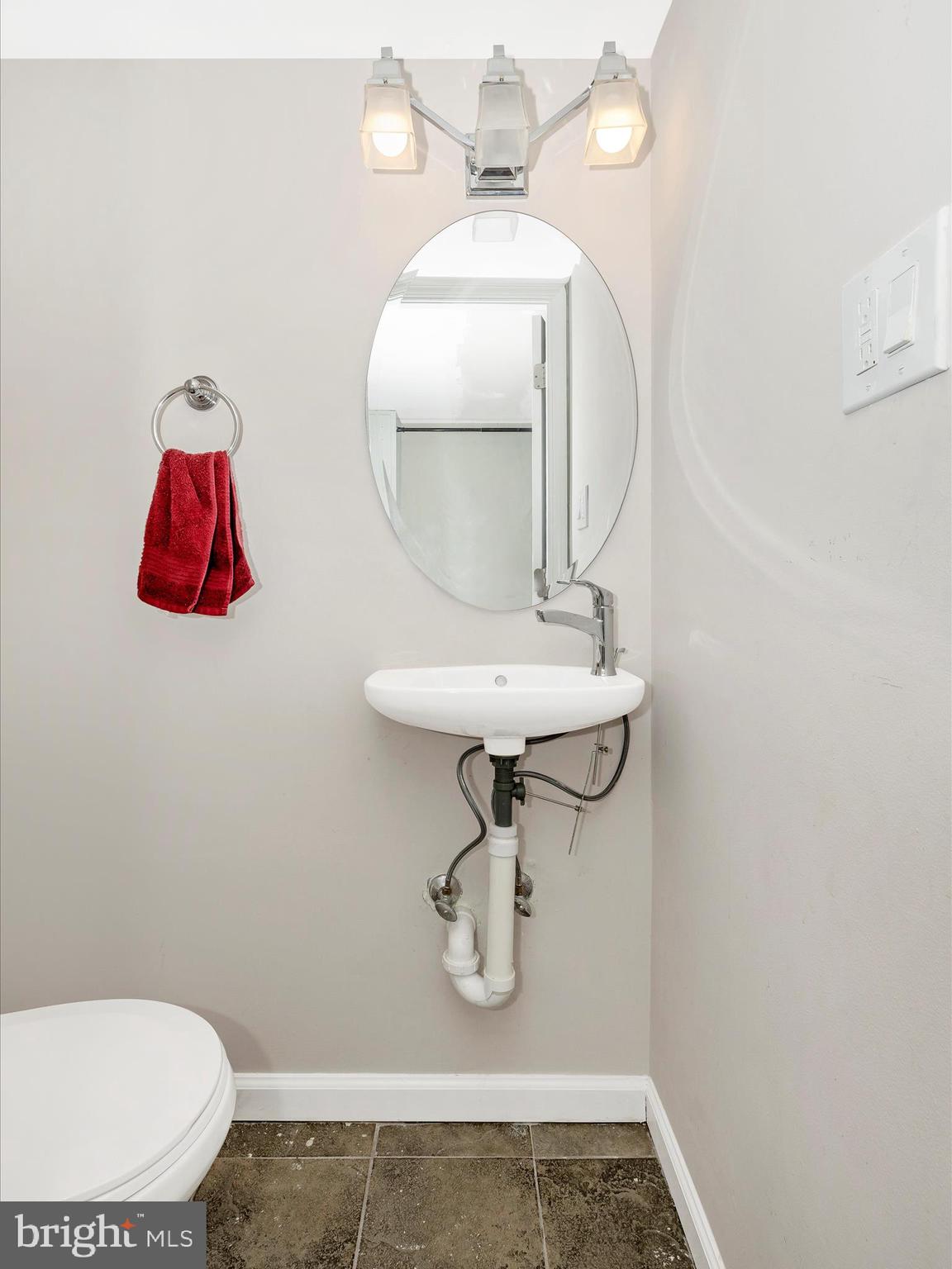 9204 Oak Tree Circle Frederick, MD 21701 - Photo 43 of 58 a bathroom with a toilet sink and mirror