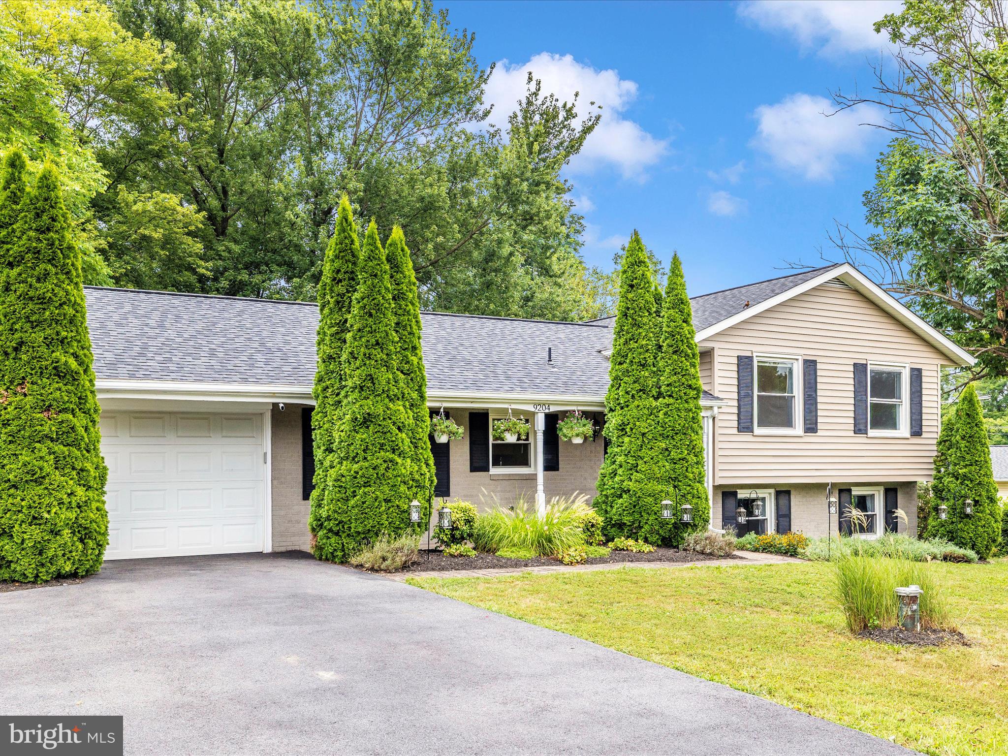 9204 Oak Tree Circle Frederick, MD 21701 - Photo 46 of 58 a front view of a house with garden