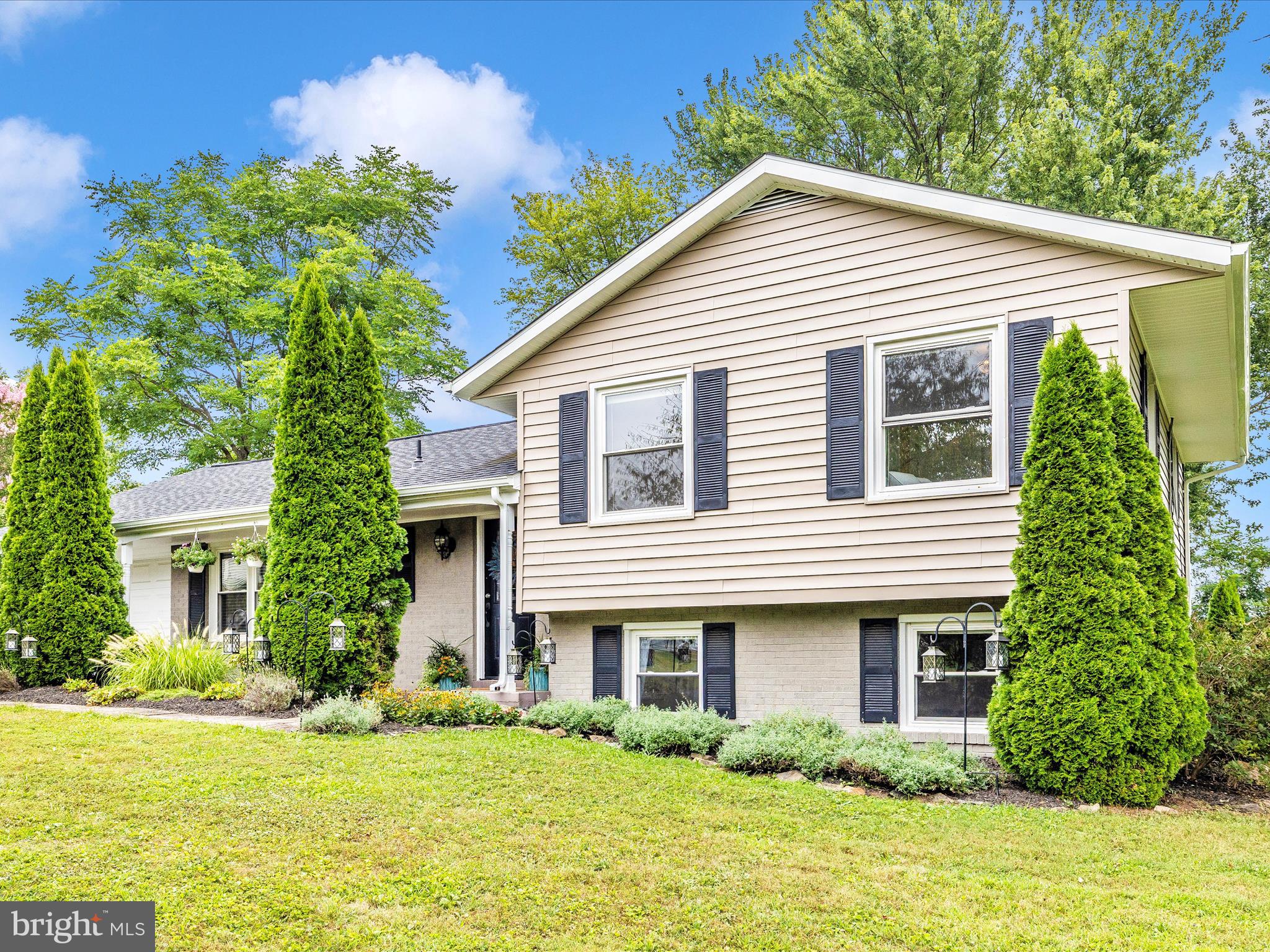 9204 Oak Tree Circle Frederick, MD 21701 - Photo 48 of 58 a view of a house with a yard potted plants and a table