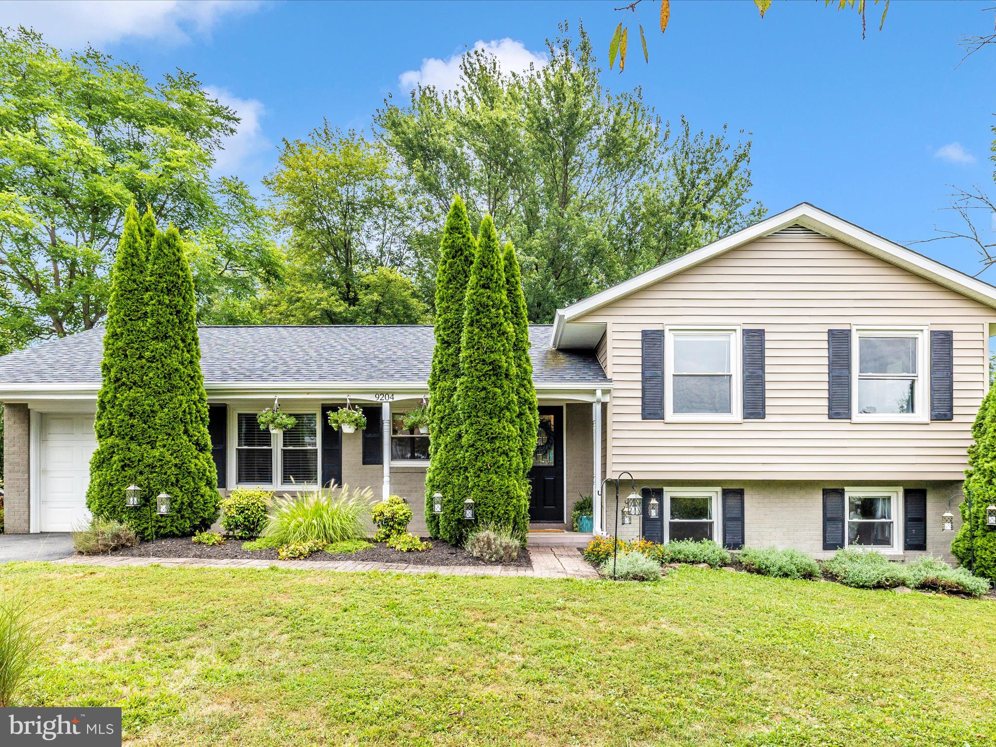 9204 Oak Tree Circle Frederick, MD 21701 - Photo 8 of 58 a front view of a house with a yard