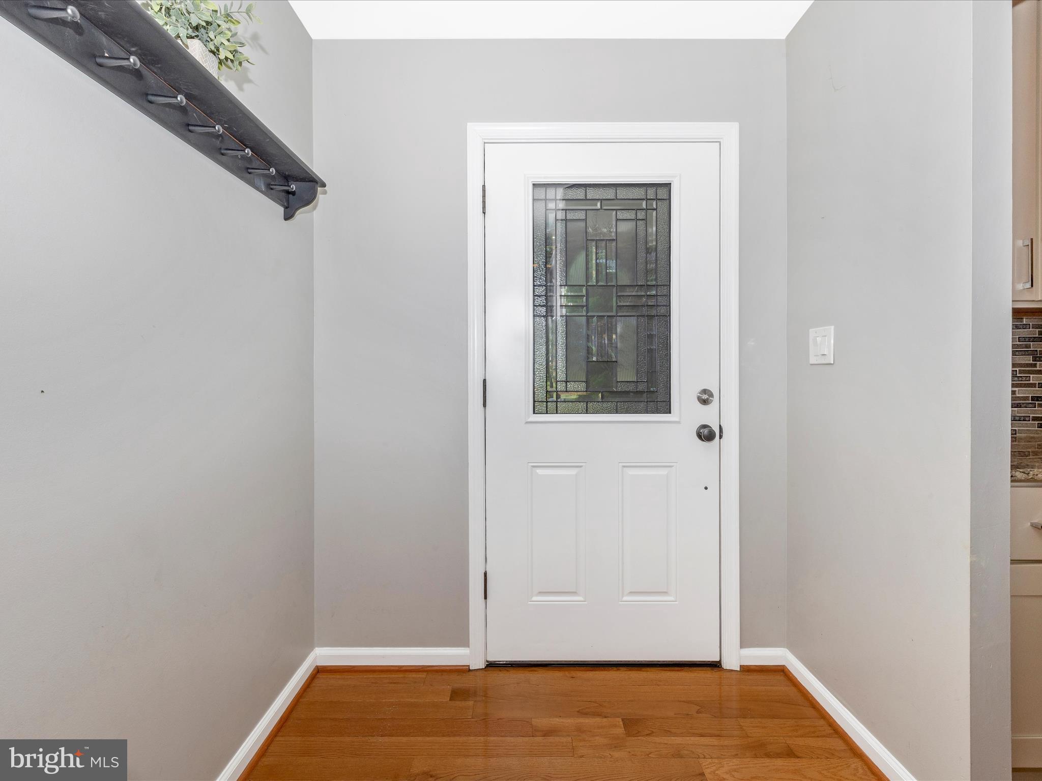 9204 Oak Tree Circle Frederick, MD 21701 - Photo 10 of 58 a view of an empty room with wooden floor and a window