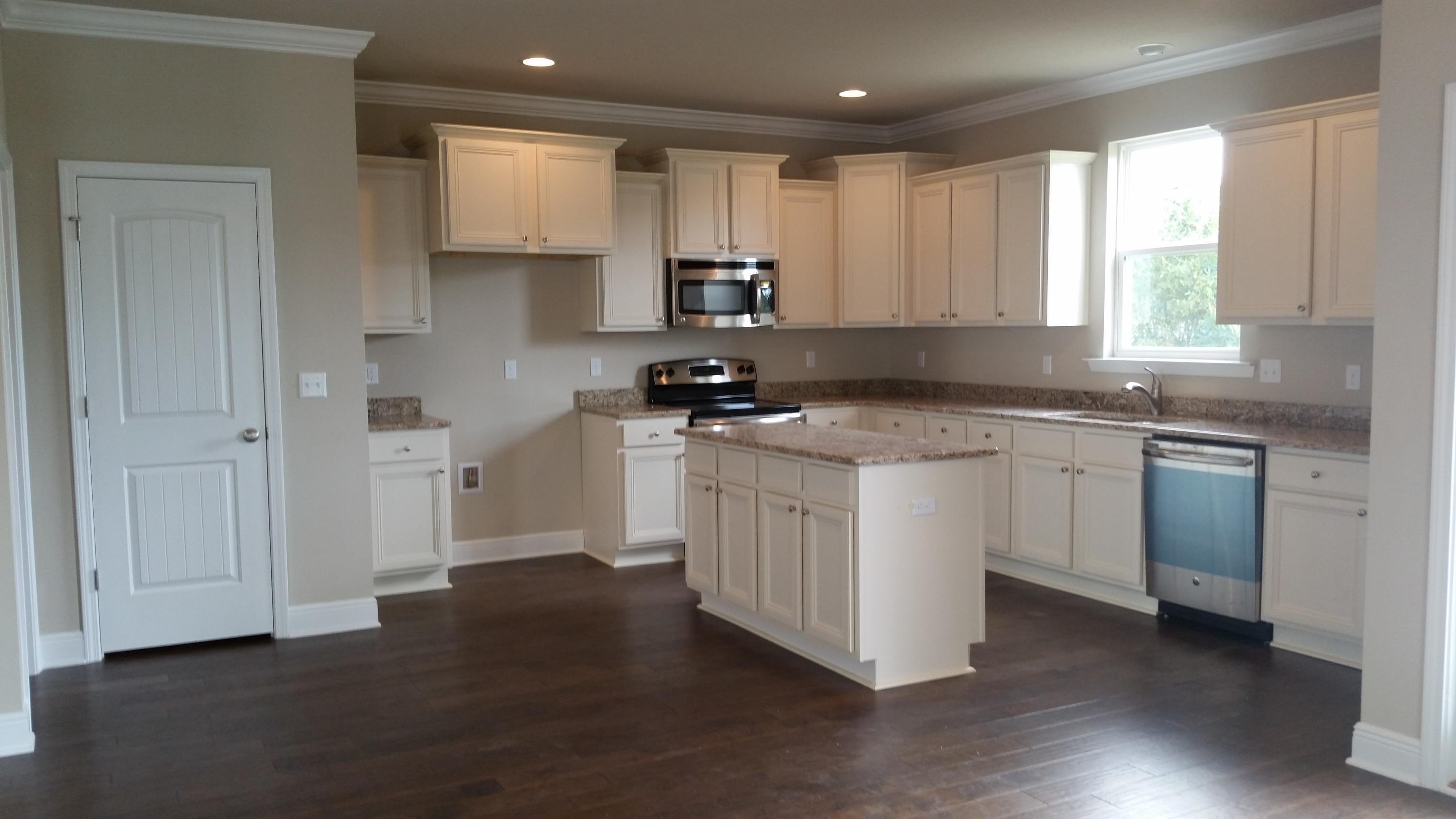 65 Grayling Way Inlet Beach, FL 32461 - Photo 8 of 36 a kitchen with a sink white cabinets and white appliances