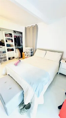 a spacious bedroom with a bed and a couch