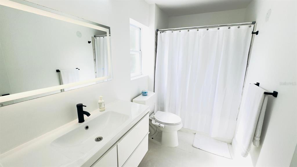 14614 Bayonne Road Orlando, FL 32832 - Photo 15 of 23 a bathroom with a sink toilet and shower