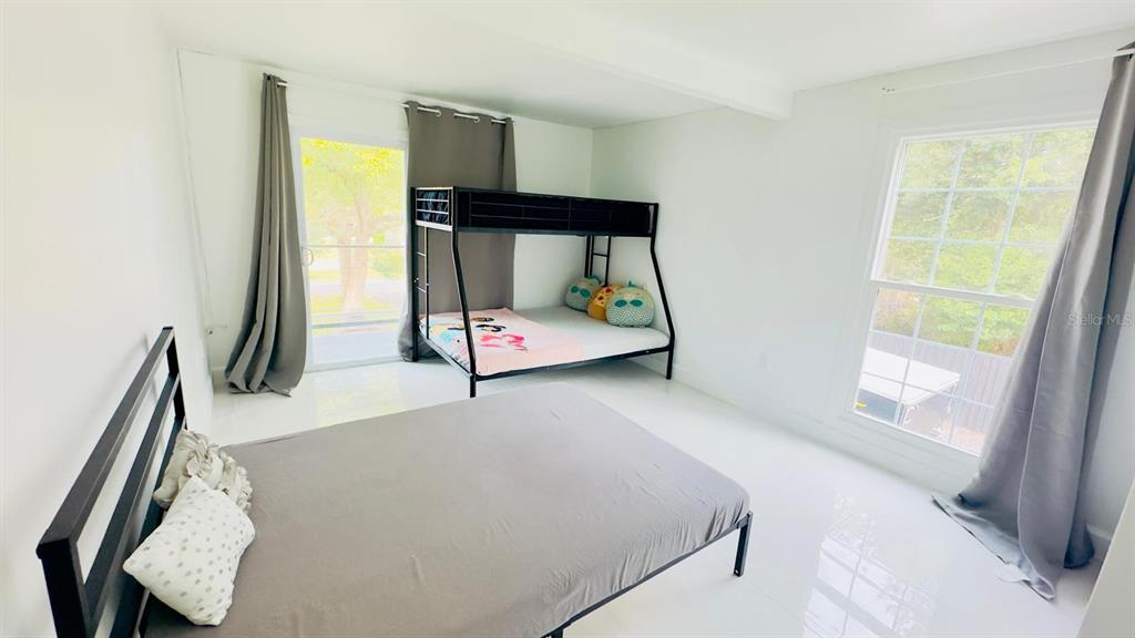 14614 Bayonne Road Orlando, FL 32832 - Photo 17 of 23 a bedroom with a bed and a window