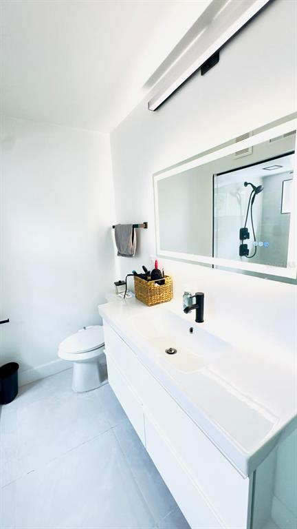 14614 Bayonne Road Orlando, FL 32832 - Photo 20 of 23 a bathroom with a sink a toilet and a mirror