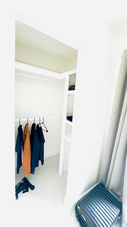 14614 Bayonne Road Orlando, FL 32832 - Photo 21 of 23 a view of walk in closet with clothes and shoes