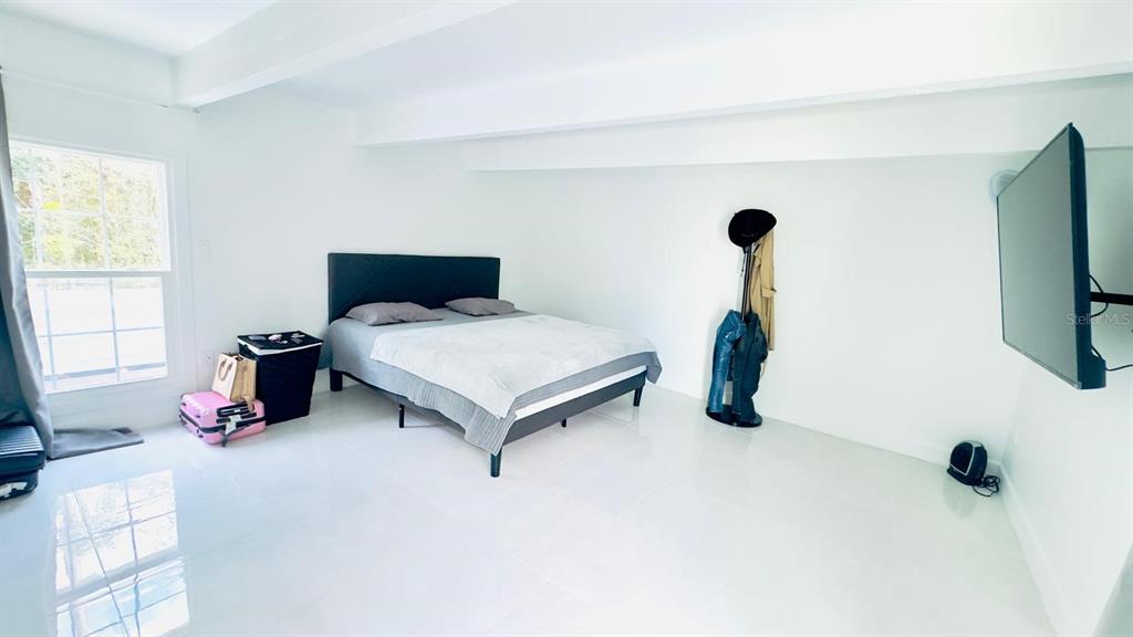 14614 Bayonne Road Orlando, FL 32832 - Photo 22 of 23 a bedroom with furniture and a flat screen tv