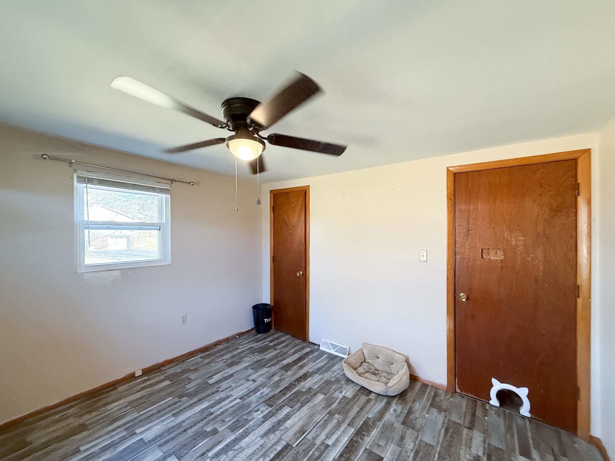 13 Indian Ridge Road Greenville, VA 24440 - Photo 13 of 17 a view of a livingroom with wooden floor and a ceiling fan