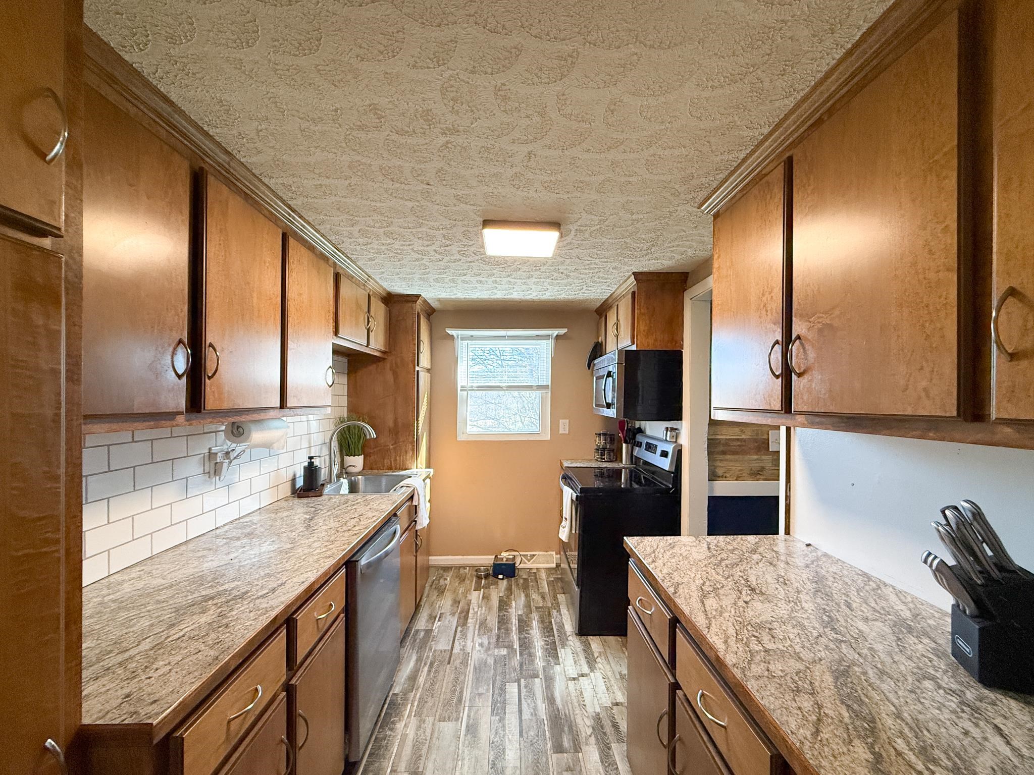13 Indian Ridge Road Greenville, VA 24440 - Photo 6 of 17 a kitchen with granite countertop kitchen island stainless steel appliances a sink stove and refrigerator