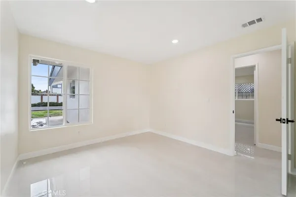 a view of a room with wooden floor and bathroom