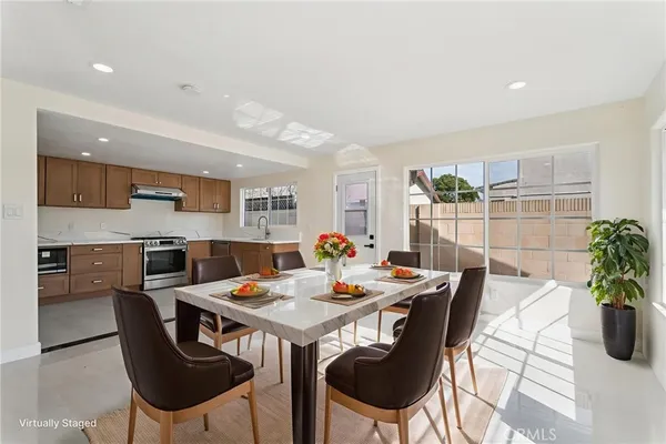 a kitchen with granite countertop a stove top oven sink and cabinets