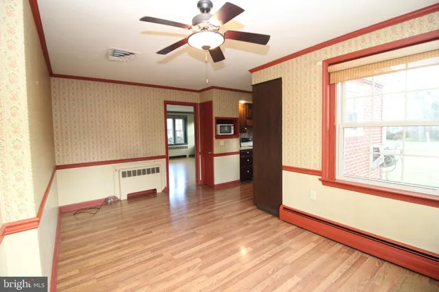 a view of an entryway with wooden floor