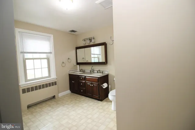 a room with a dresser and a window