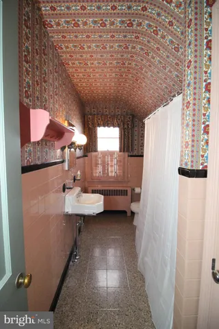 a bathroom with a sink toilet and a shower