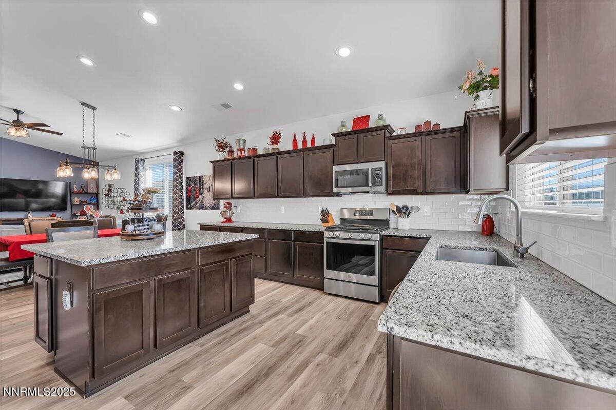 18722 Knott Crk Court Reno, NV 89508 - Photo 16 of 56 a kitchen with kitchen island granite countertop a sink cabinets and stainless steel appliances