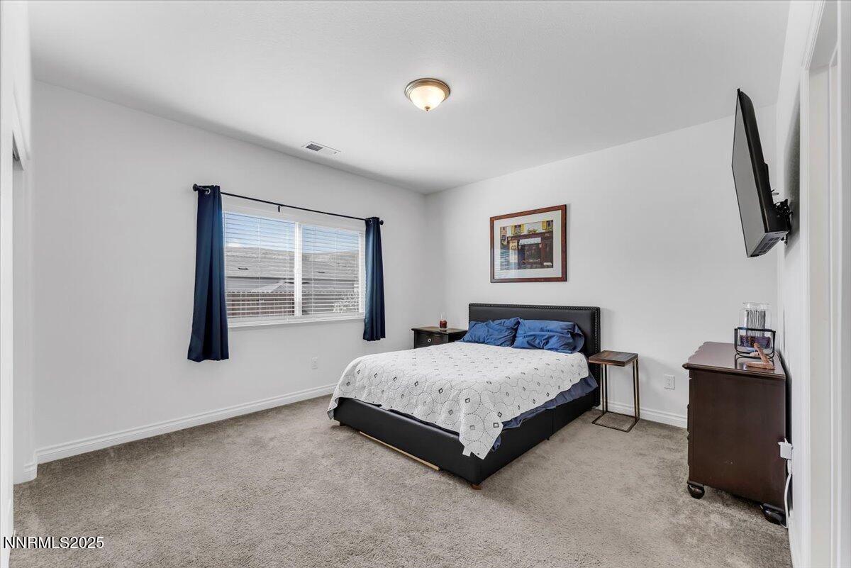 18722 Knott Crk Court Reno, NV 89508 - Photo 21 of 56 a bedroom with a bed and dresser with mirror