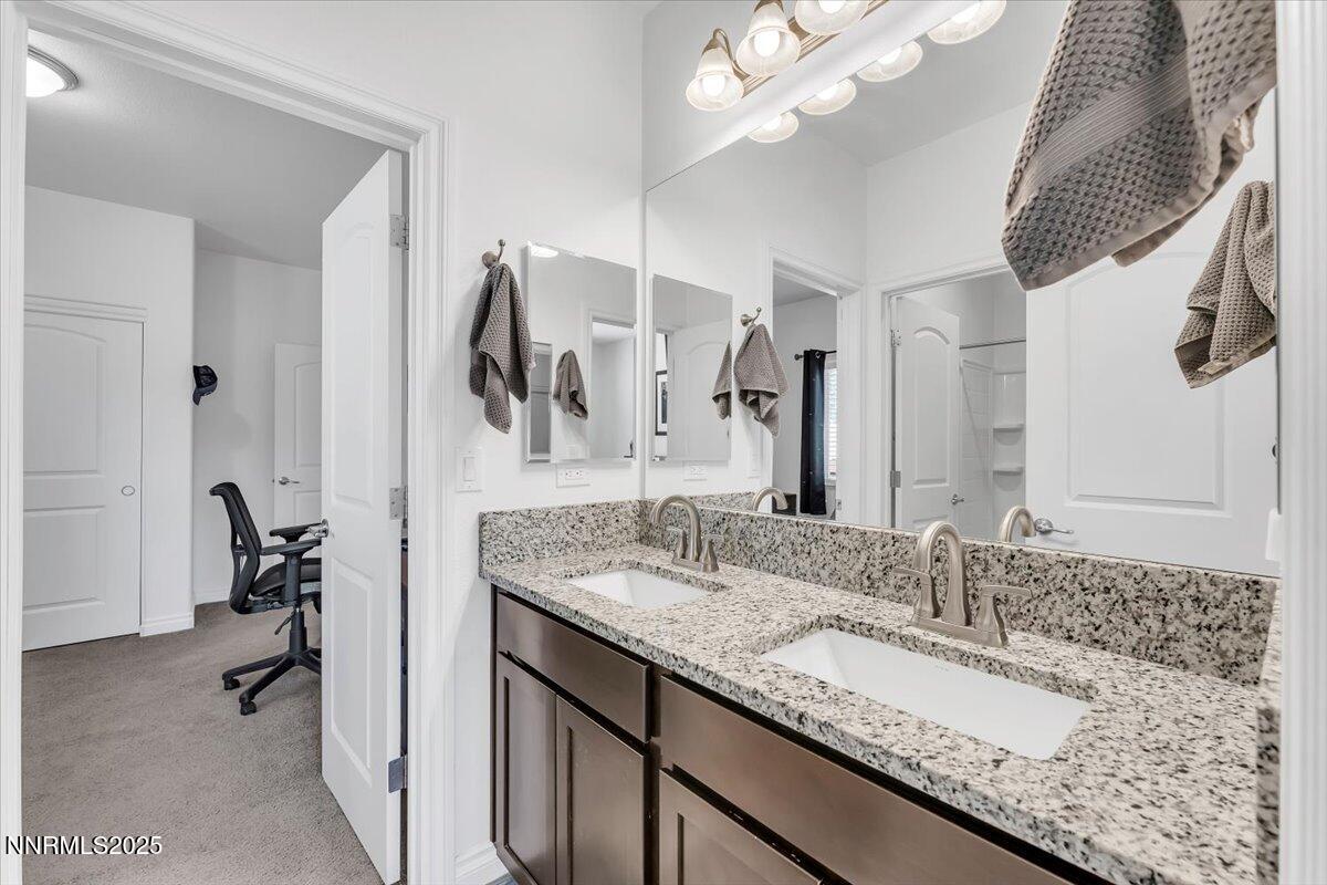 18722 Knott Crk Court Reno, NV 89508 - Photo 23 of 56 a bathroom with a granite countertop sink and a mirror