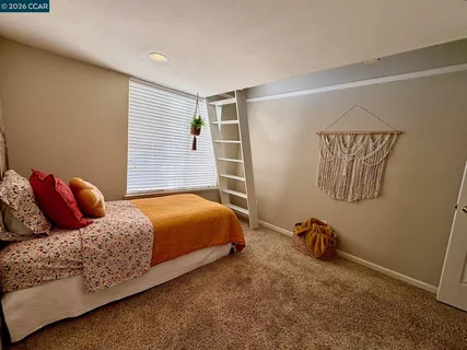 a bedroom with a bed and dresser