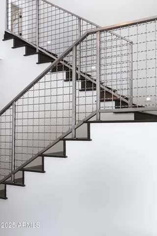 a view of a patio with a table and chairs and couches with wooden fence