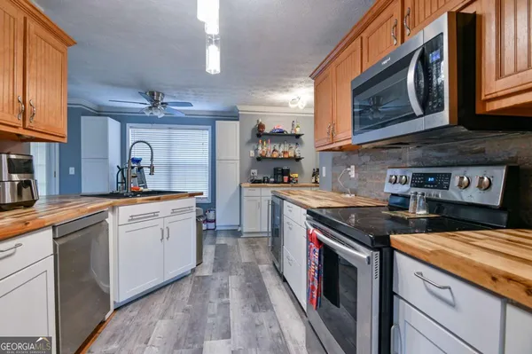 a kitchen with stainless steel appliances granite countertop a sink and cabinets