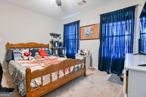 a bedroom with a bed and dresser