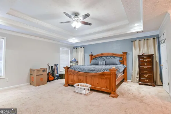 a bedroom with a bed and a chandelier