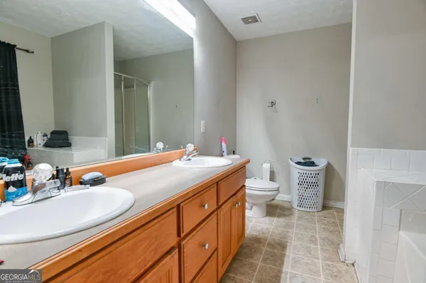 a bathroom with a sink double vanity and a toilet