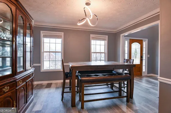 a view of a livingroom with furniture window and wooden floor
