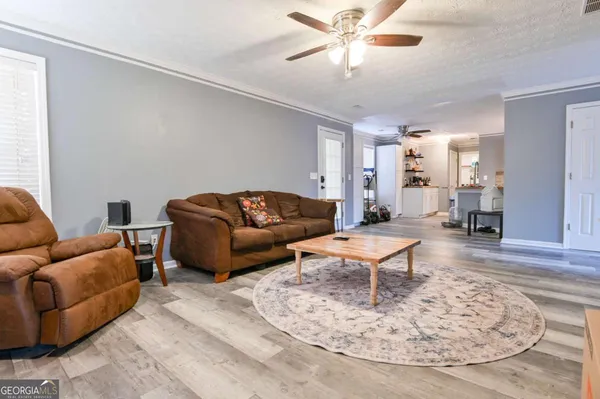 a living room with furniture and a chandelier