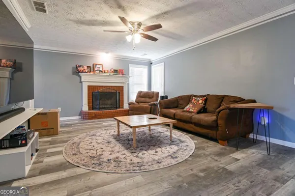 a living room with furniture and a fireplace