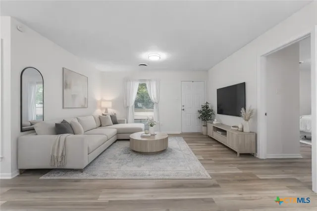 a living room with furniture and a flat screen tv