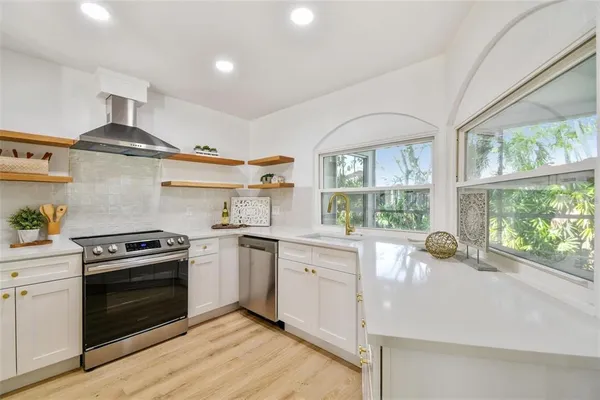 a kitchen with a stove a sink and a stove