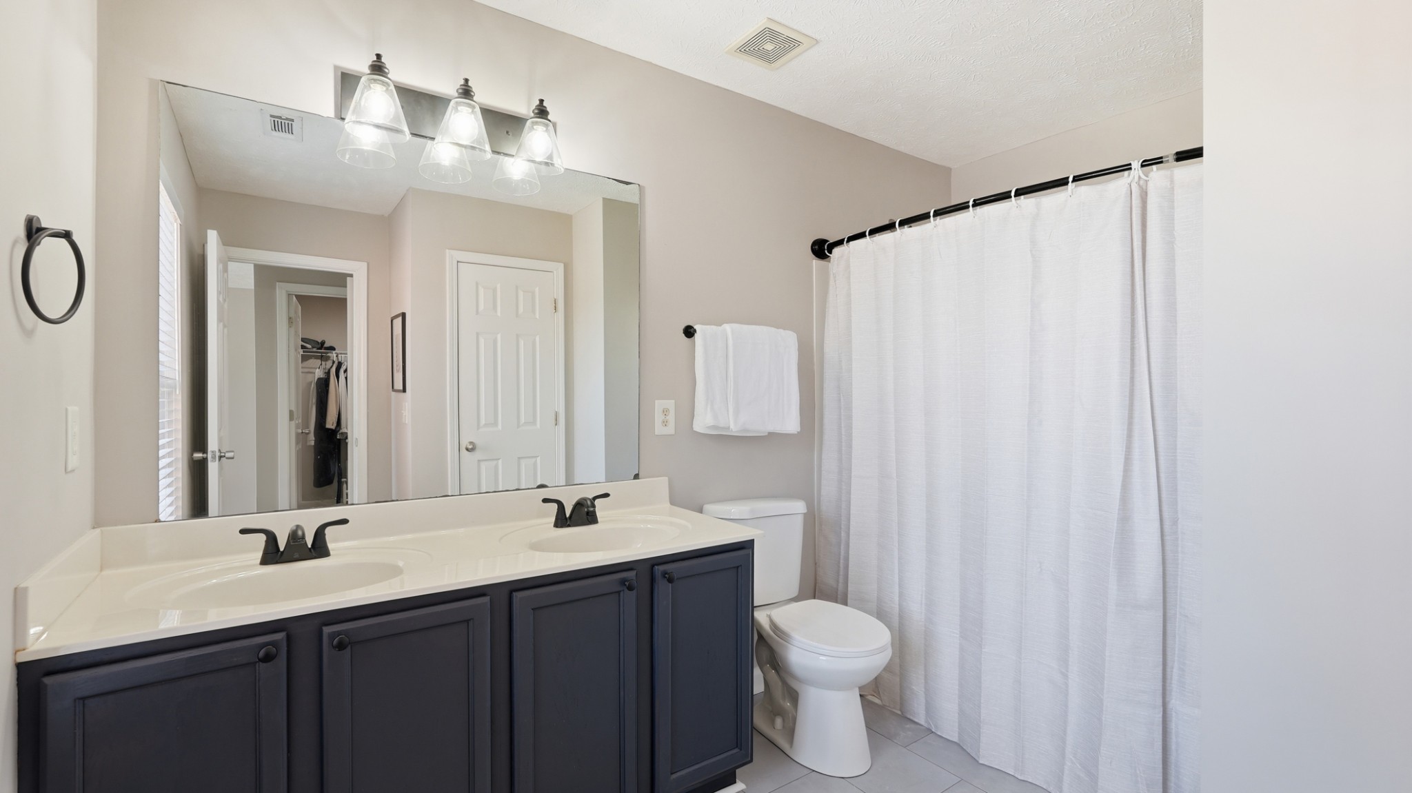 8215 Rossi Road Brentwood, TN 37027 - Photo 15 of 22 a bathroom with a double vanity sink toilet and a mirror