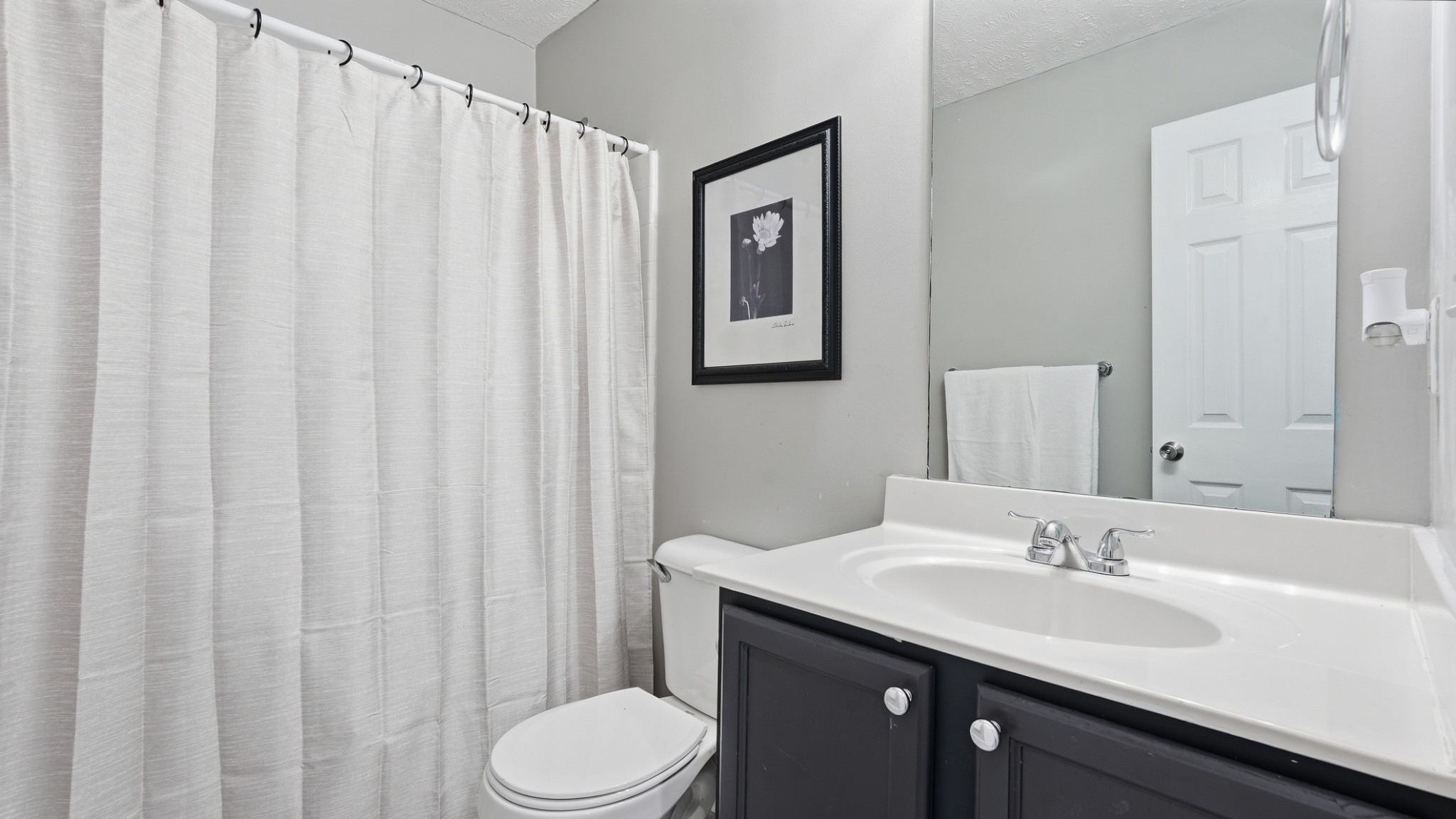 8215 Rossi Road Brentwood, TN 37027 - Photo 17 of 22 a bathroom with a granite countertop sink and a mirror