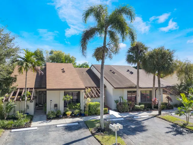a aerial view of a house with a yard and potted plants
