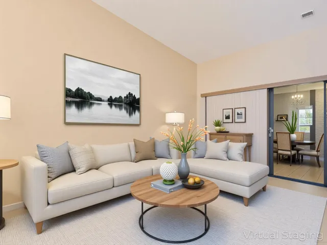 a living room with furniture and a potted plant