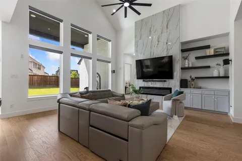 a living room with fireplace furniture and a flat screen tv